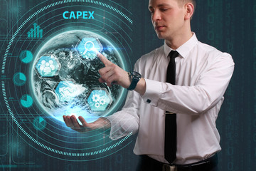Business, Technology, Internet and network concept. Young businessman working on a virtual screen of the future and sees the inscription: Capex