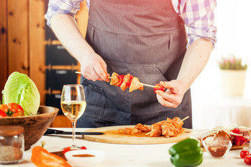male preparing chicken for cooking