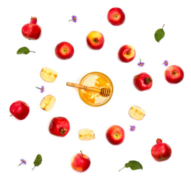Honey, red apples, garnets and violet flowers on a white background. Top view, flat lay
