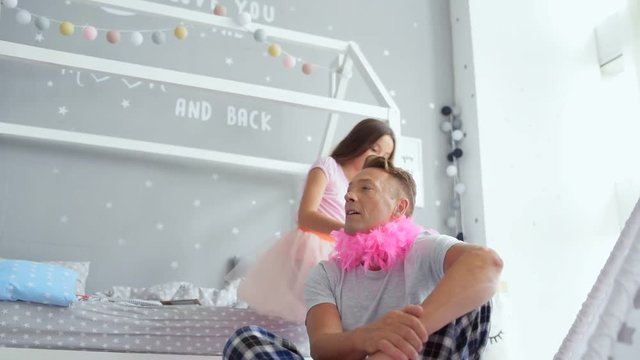 Positive father having fun with his little daughter