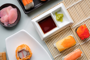 Sushi set / View of japanese food on light blue tile. Sushi set. Top view.