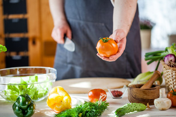 Chef cutting fresh and delicious vegetables for salad
