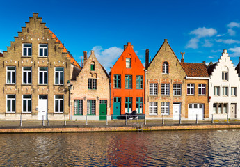 Brugge (Bruges), Belgium. Colored houses in the traditional architecture style and canal with water.
