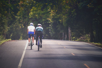 Naklejka premium couples of man riding touring bicycle on mountain road