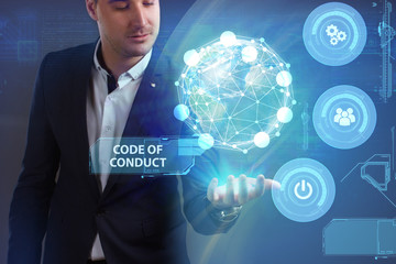 Business, Technology, Internet and network concept. Young businessman working on a virtual screen of the future and sees the inscription: Code of conduct