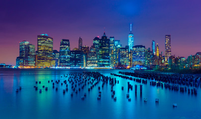 New York City at night. Manhattan skyline. Skyscrapers reflected in water. NY, USA