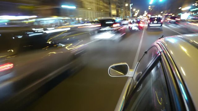 Driving a car time-lapse. Night, Camera gripped on the side / reference. POV - point of view. White car ride. City, blurred motion, fast driving. HD. Hyperlapse