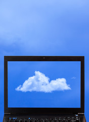 A laptop with clouds - Cloud computing concept