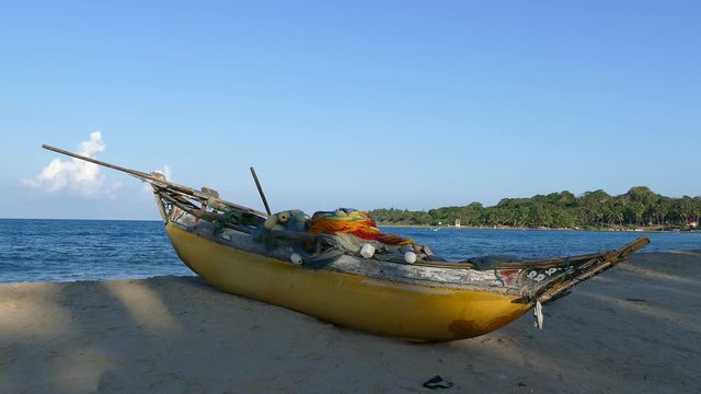 Traditional yellow catamaran fishing boat at the beach of Arugam Bay in Sri Lanka