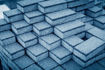 CLOSE UP BLACK AND WHITE IMAGE OF STACKED CONCRETE TILES