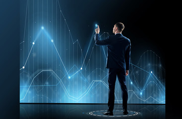 businessman in suit touching virtual graph