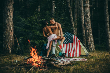 American flag. Sexy couple. Camping, travel, tourism, sexy. Couple in love. Life.
