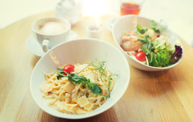 close up of pasta in bowl on table at restaurant