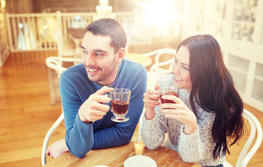 happy couple drinking tea at cafe