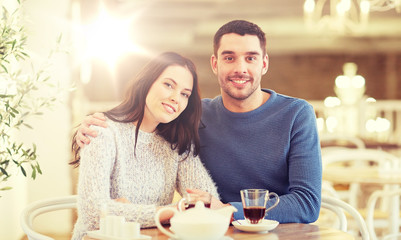 happy couple drinking tea at restaurant