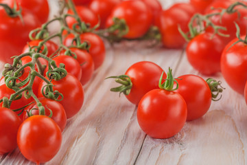 on a wooden background cherry tomatoes on the branches