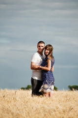 Happy young couple enjoying in the wheat field, summer season