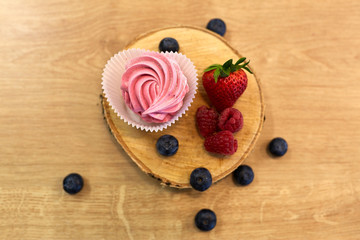 zephyr or marshmallow with berries on stand