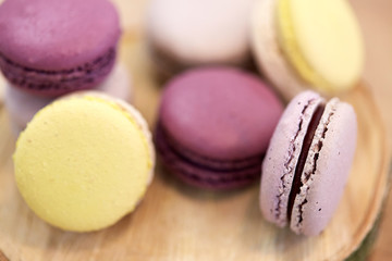 close up of different macarons on wooden stand