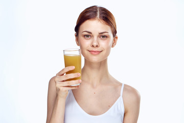 Woman holding a glass of juice on white isolated background, diet, fitness