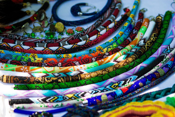 Fashionable handmade accessories for women. Decorative beads necklaces and bracelets. Strands of small colorful beads necklaces
