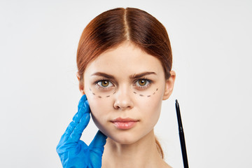 Young beautiful woman on white isolated background, portrait, outline of face, plastic surgery