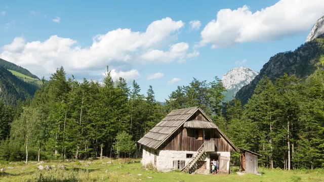 Time lapse of old alpine hut - homestead with meadow and woods in the Alps, Robanov kot, Slovenia