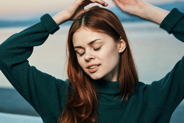 Fototapeta premium Woman dreams, on the background of the sea, embankment