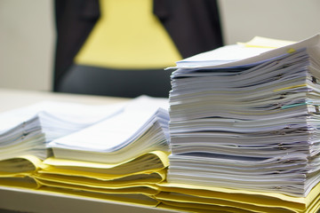 Pile of organized but unfinished business documents on desk in the office,  business and job concept