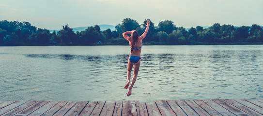 Girl jumping into water