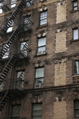 Fototapeta na wymiar Wall of the house with fire stairs in downtown New York