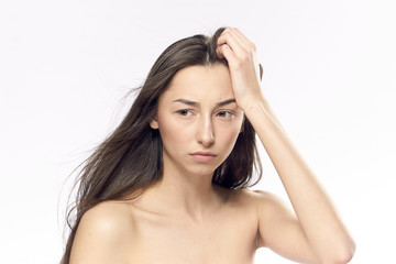 Naklejka premium Young beautiful woman on white isolated background, portrait, emotions