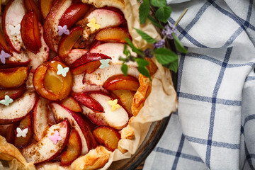 pie with plums near a window