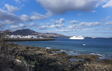View from the shore of the ocean to the port of the village of Playa Blanca, Lanzarote Island