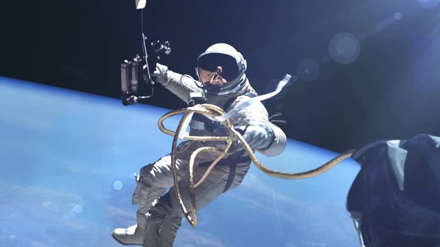 Astronaut in outer space against the Earth background. Elements of this image furnished by NASA.