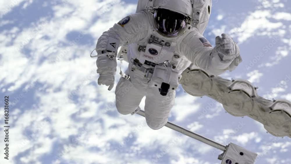 Poster astronaut are moving in the camera in outer space against the earth background. elements of this ima