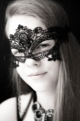 Obraz premium The smiling model in a black mask on a face