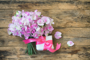 delicate bouquet of sweet peas and gift box