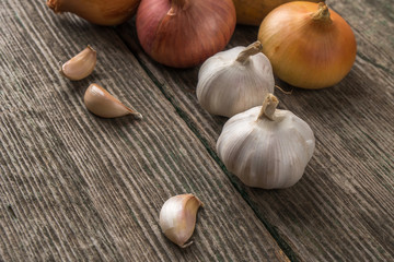 Garlic and onion on an old table, vegetables