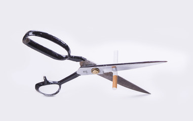Cut cigarette with scissers and stop smoking to save your health