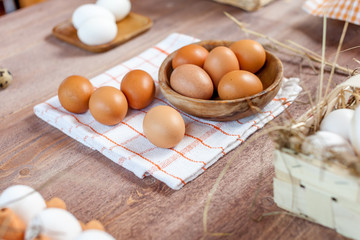 Close-up view of raw chicken eggs on wooden background