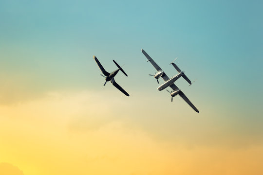 Silhouette of an airplane performing flight at airshow. F4U Corsair and B25 plains