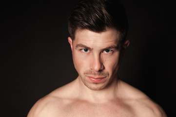 Fototapeta premium Portrait of sporty man. Caucasian male model in studio shoot.