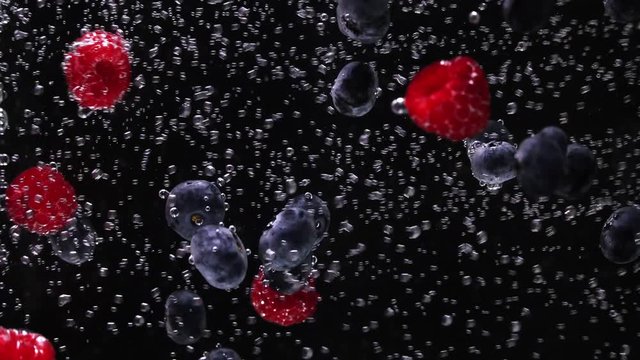  berries and  ice falls into the water, Background,  Water bubbles in slow motion