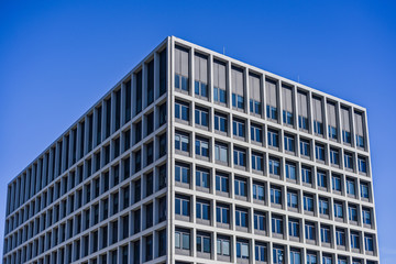 Rectangle Building With Lots Of Big Glass Windows And Blue Sky Background