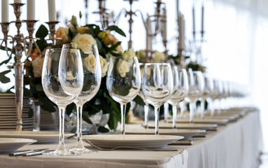 Wedding decorated table. Luxury light decor on table in restaurant