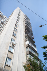 Fototapeta na wymiar High-rise condominium or apartment burning. Fire in apartments of a large tenement-house.