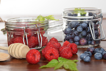 blueberries and raspberries in jars for the winter tea