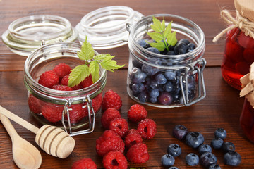 blueberries and raspberries in jars for the winter tea