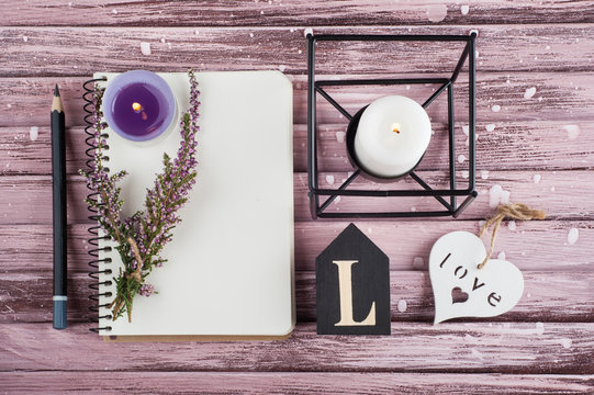 Notebook, heather flowers, candles